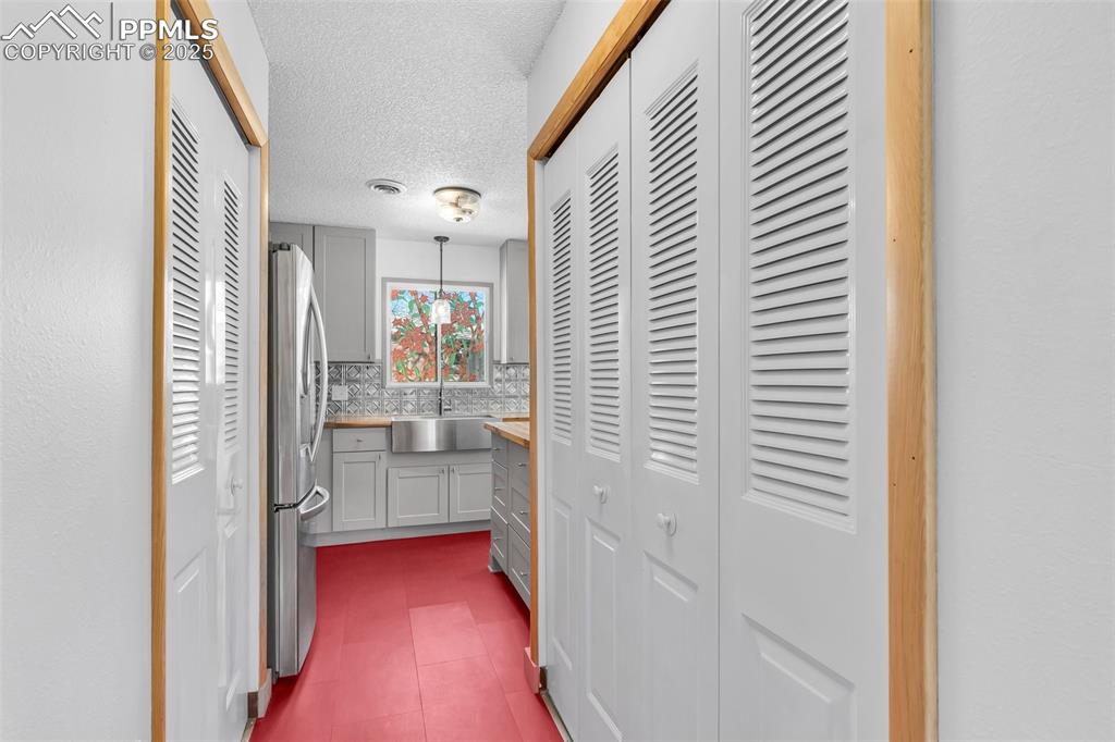 Image 20 of 32: Kitchen hall, washer and dryer to the right