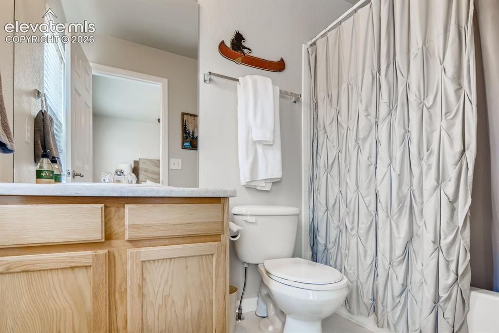 Image 17 of 23: Bathroom featuring a light wood-finish vanity with a light-toned countertop