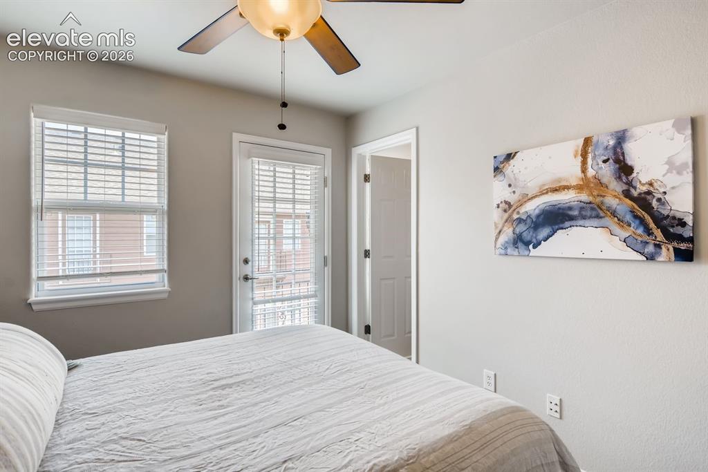 Image 18 of 23: White interior door leading to an exterior balcony, complemented by a windo
