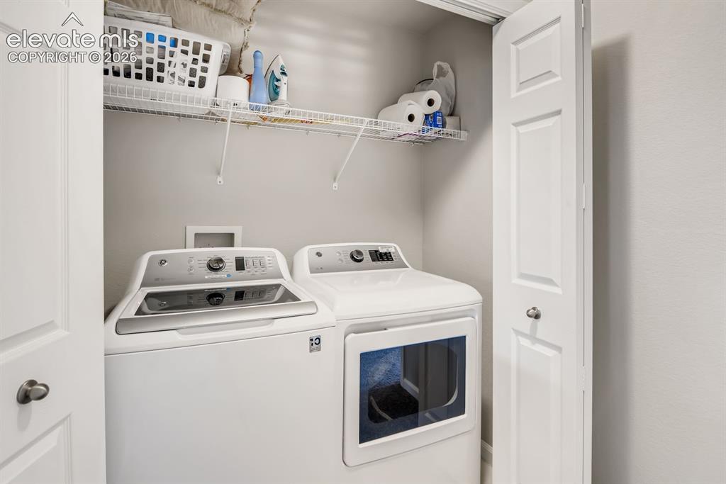Image 19 of 23: Dedicated laundry closet featuring a top-load washing machine, front-load d