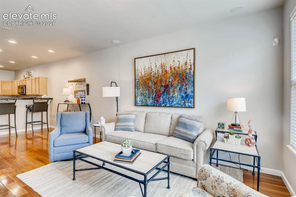 Image 4 of 23: Open-concept living space featuring wood-finish flooring and recessed light