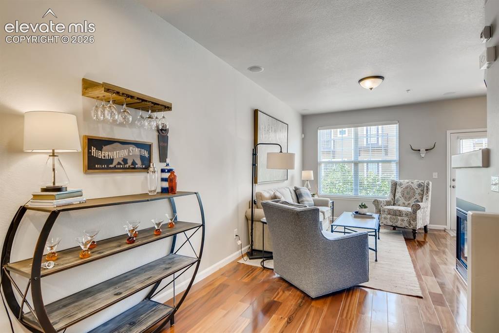 Image 7 of 23: Open-concept living area featuring wood-finish flooring throughout
