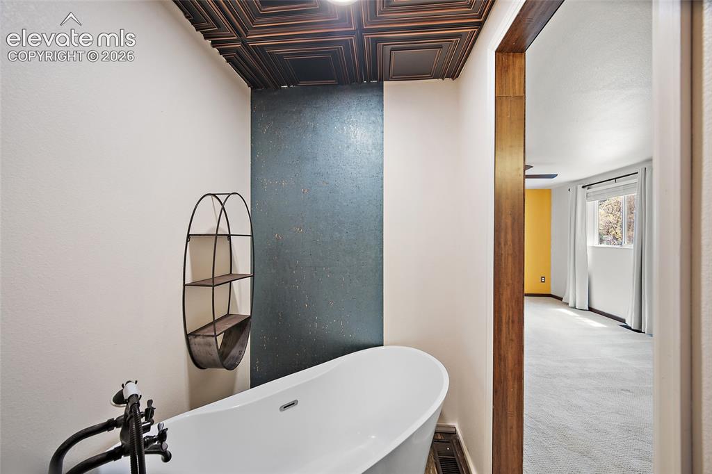 Image 30 of 49: Primary bedroom soaking tub