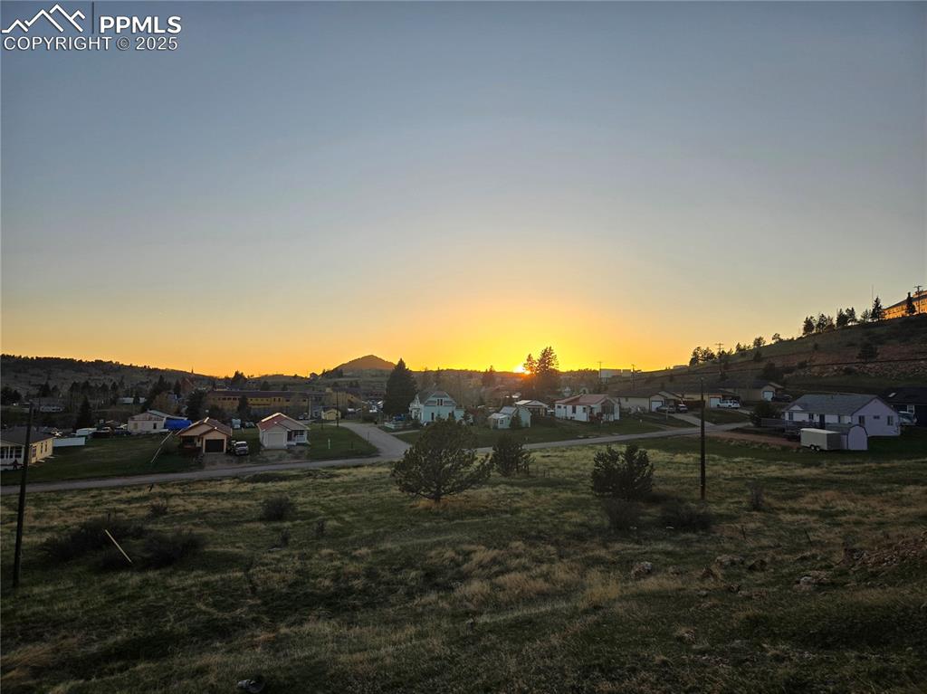 Image 2 of 10: View of mountain background with nearby suburban area