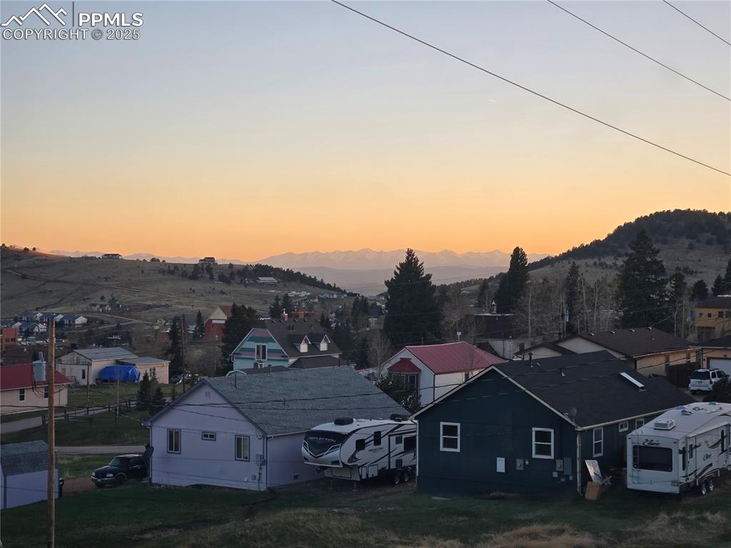 Image 8 of 10: Aerial view at dusk of a mountain view and a residential view
