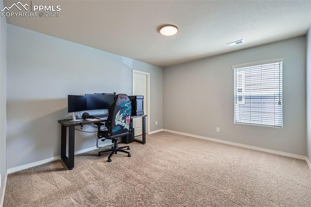 Image 19 of 29: Carpeted office featuring baseboards