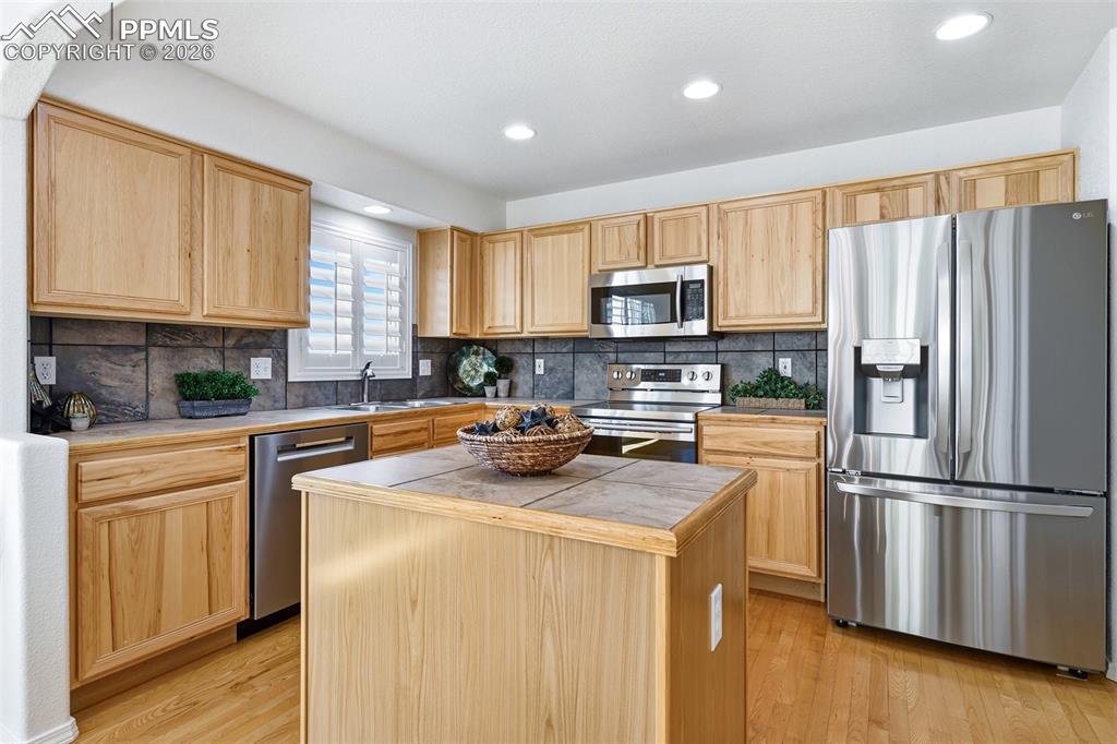 Image 12 of 41: Kitchen has stainless appliances, views, hardwoods and...