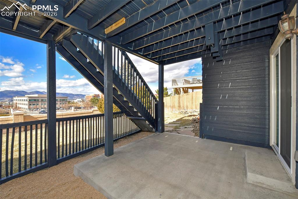 Image 32 of 41: Covered lower level patio