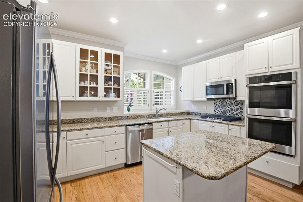 Image 10 of 40: Ktchen featuring granite countertops, a center island, and abundant clean w