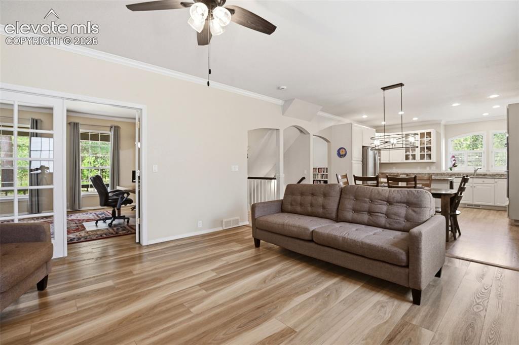 Image 17 of 40: Great room leads to the current office through french doors.