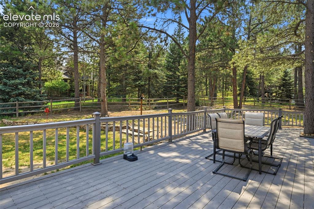 Image 2 of 40: Beautifully treed back yard and composite deck. Completely fenced and room 