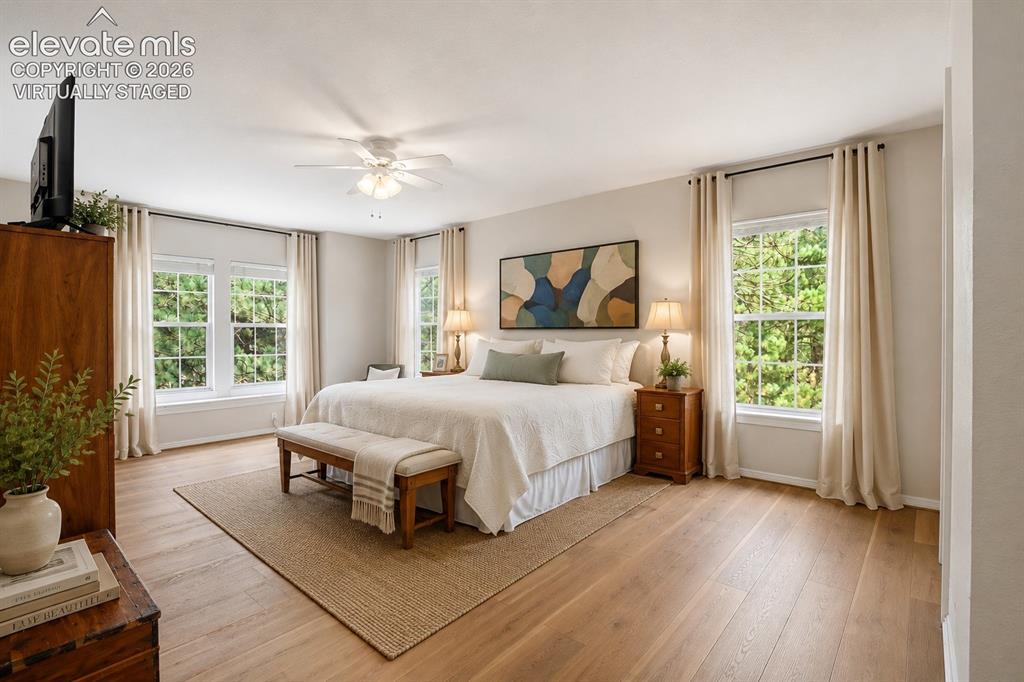 Image 20 of 40: Virtually staged, spacious primary bedroom with ensuite and walk-in closet.