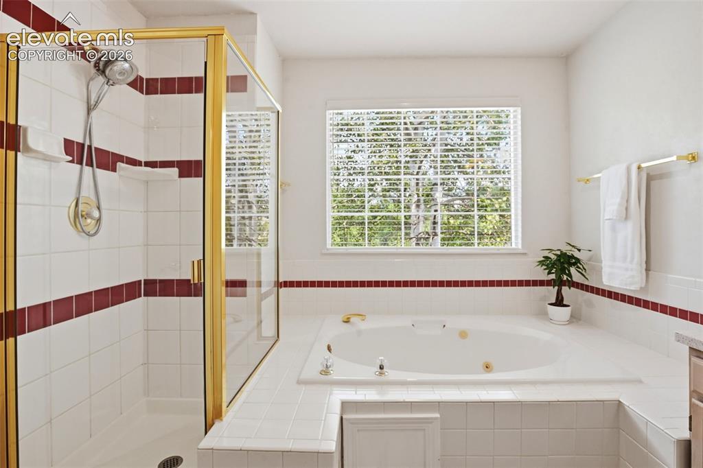 Image 24 of 40: Well maintained 5 piece primary bath with jetted tub, and stand alone showe