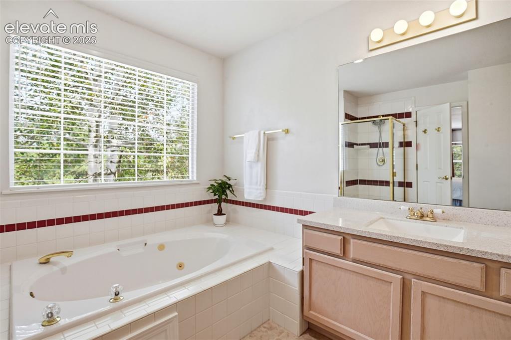 Image 25 of 40: Primary bath has dual vanities.
