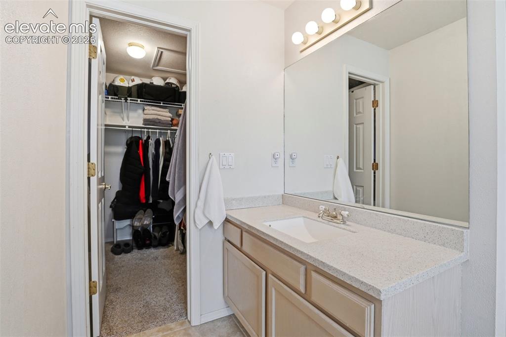 Image 26 of 40: Second separate vanity leads to the walk in closet