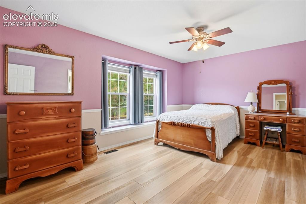 Image 28 of 40: As-is secondary upstairs bedroom—simply could use a fresh coat of paint!