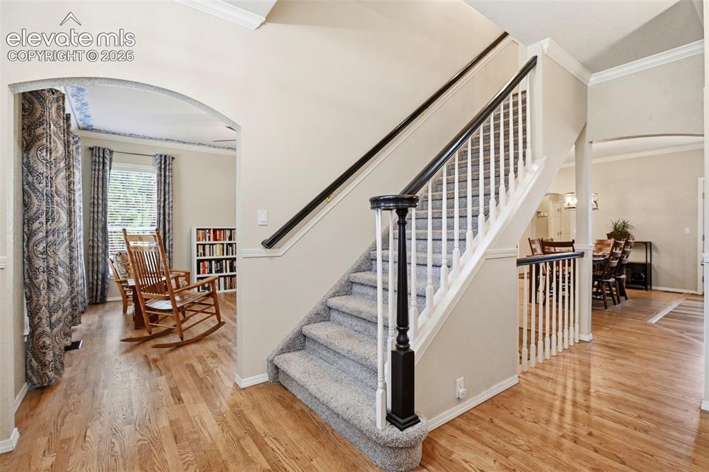Image 3 of 40: Front entry and arched doorway opens to the dining room on the left
