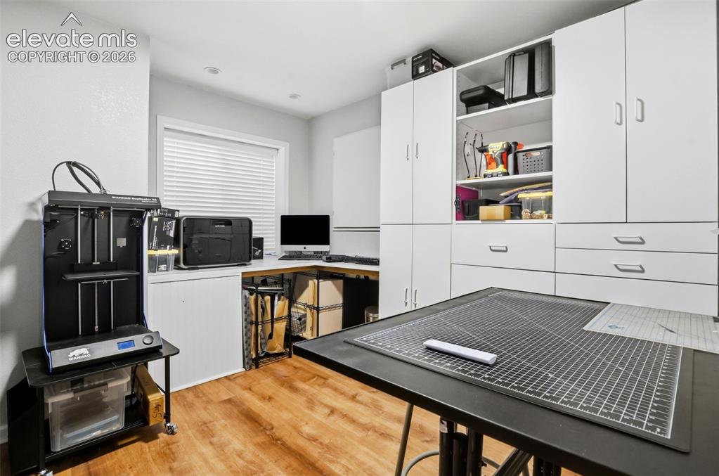 Image 35 of 40: Basement studio/craft room with recessed lighting, newer flooring, and buil