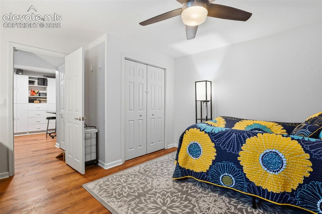 Image 36 of 40: Basement Bedroom with newer flooring, ceiling fan and closet.