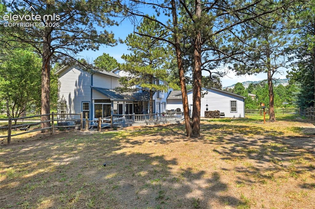 Image 37 of 40: Treed and fenced room to run back yard