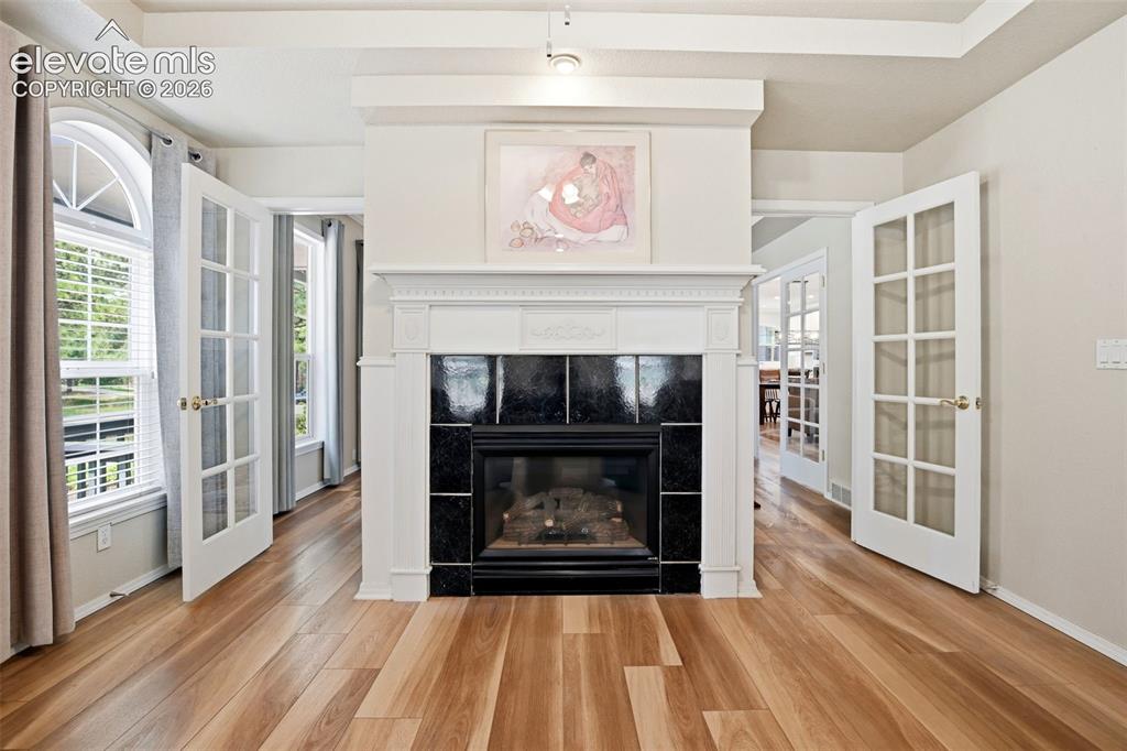 Image 8 of 40: Living room addition on the Main level - with gas log fireplace that leads