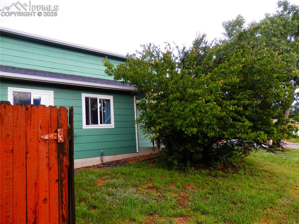 Image 2 of 29: View of side of property with a lawn