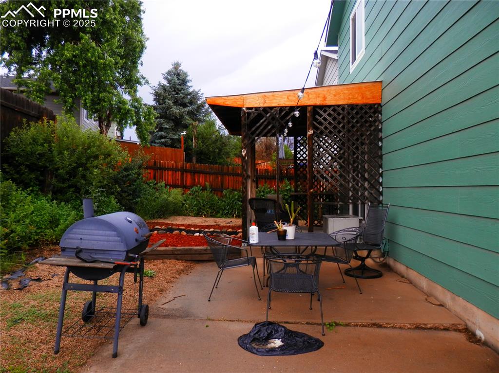 Image 3 of 29: View of patio / terrace with a grill and outdoor dining area