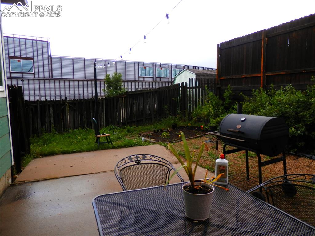 Image 4 of 29: Fenced backyard featuring a patio area