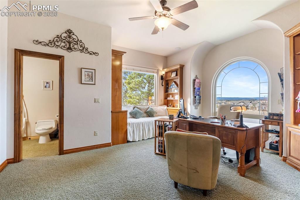 Image 10 of 50: Home office with a ceiling fan and carpet floors