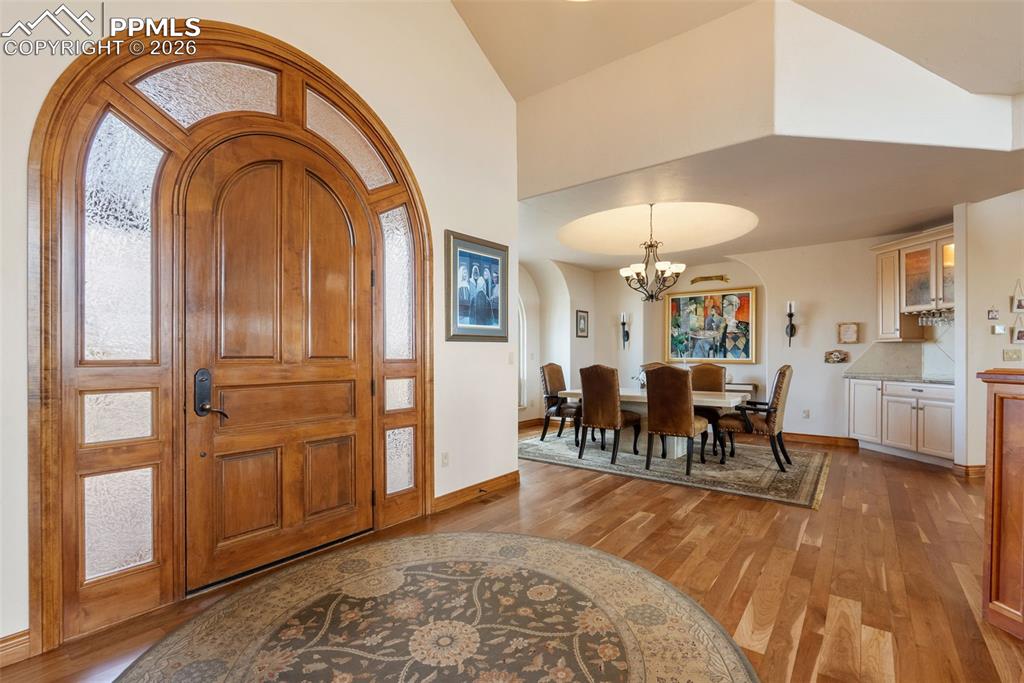 Image 3 of 50: Foyer entrance with light wood-type flooring, arched walkways, plenty of na