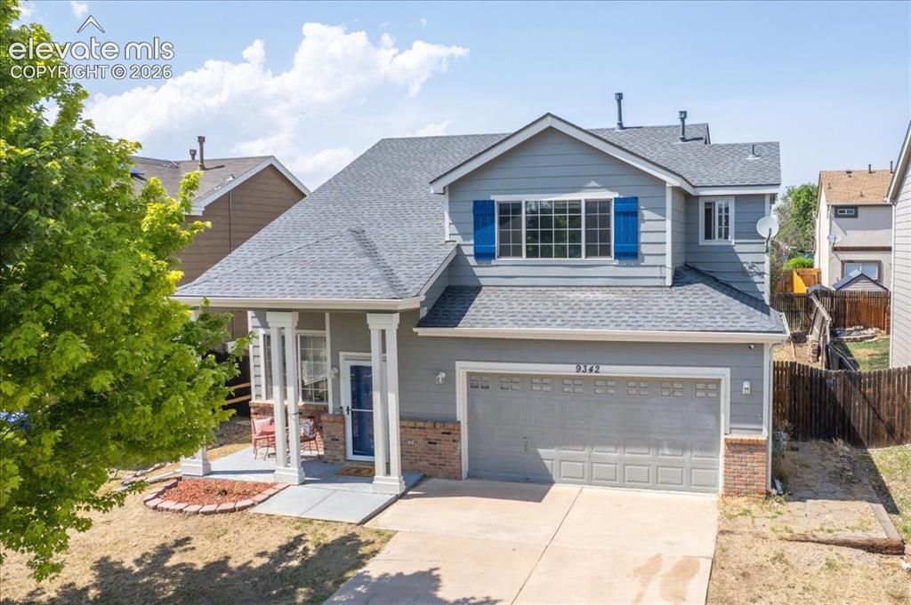 Image 27 of 36: Covered front porch of a 1,603 sq ft home with vaulted ceilings