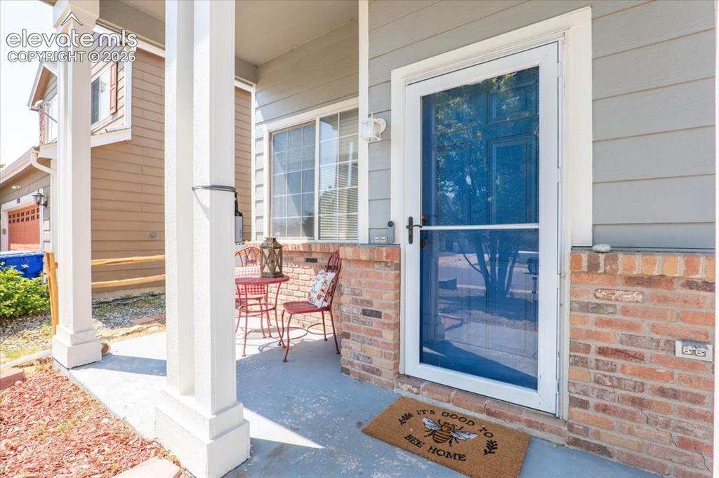 Image 8 of 36: Covered porch for enjoying morning and evening beverages