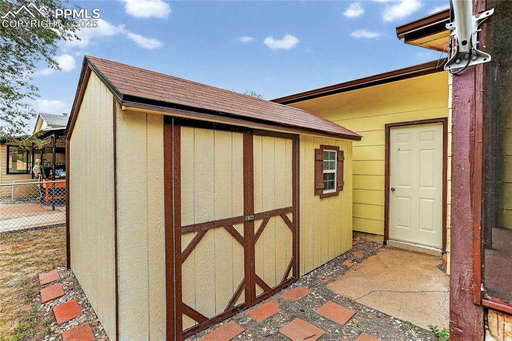 Image 12 of 15: Storage shed and garage access