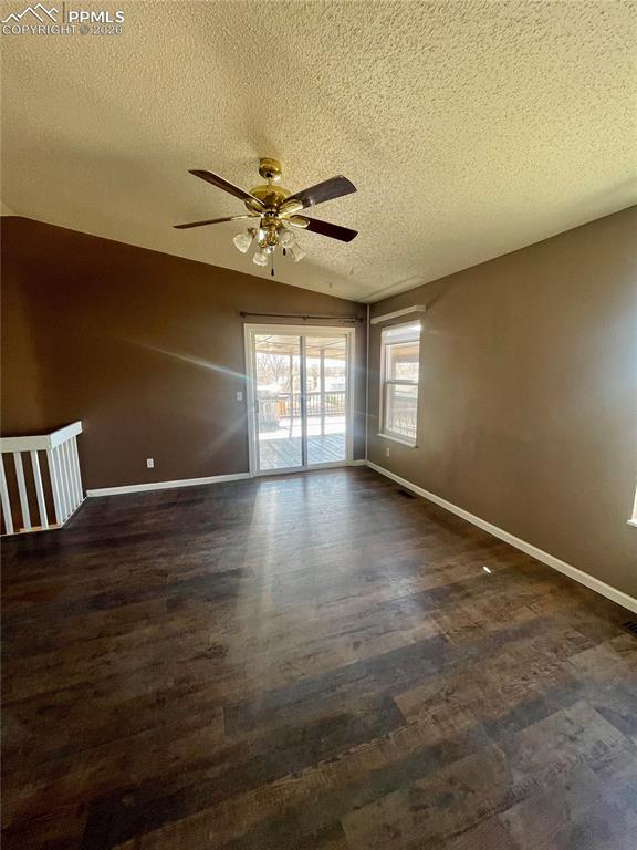 Image 3 of 29: Spare room with ceiling fan and dark wood-type flooring
