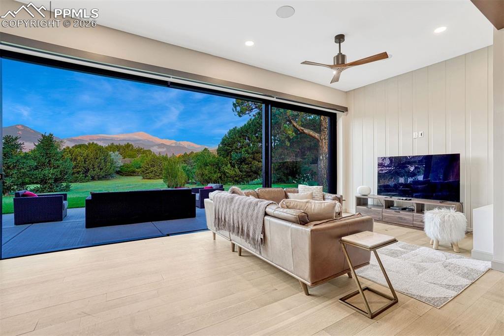 Image 10 of 46: Entertainment space with high ceilings and new Lutron electric solar shades