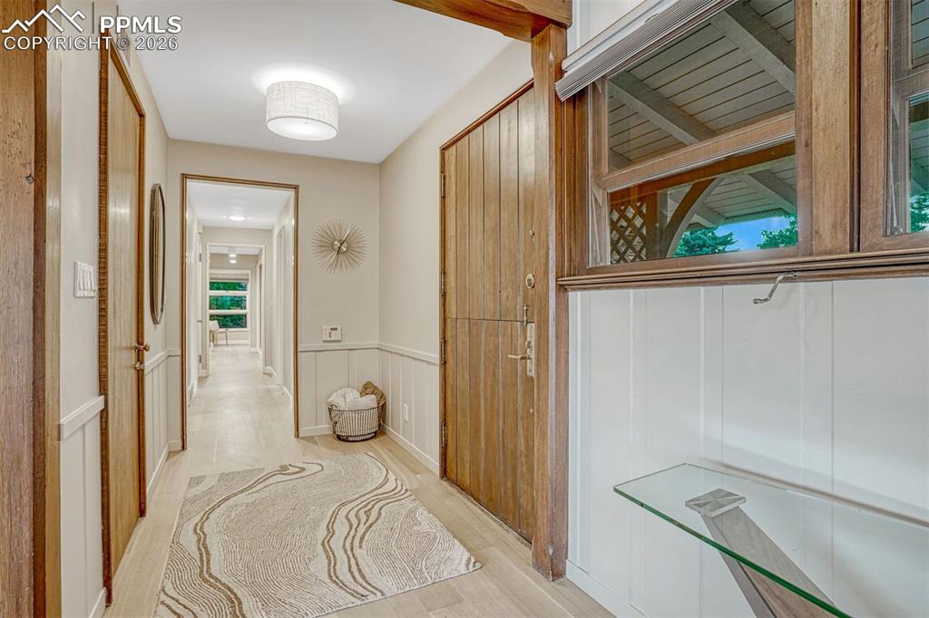 Image 16 of 46: Custom Dutch entry door and gorgeous wood trim and white oak hardwood floor