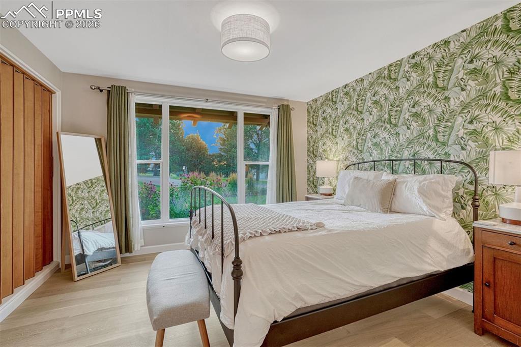 Image 20 of 46: Bedroom with 6" white oak hardwood floors and closet organization system. 
