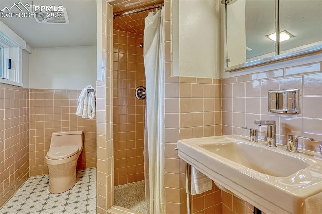 Image 26 of 46: Charming retro bathroom with vintage character and pristine, updated condit