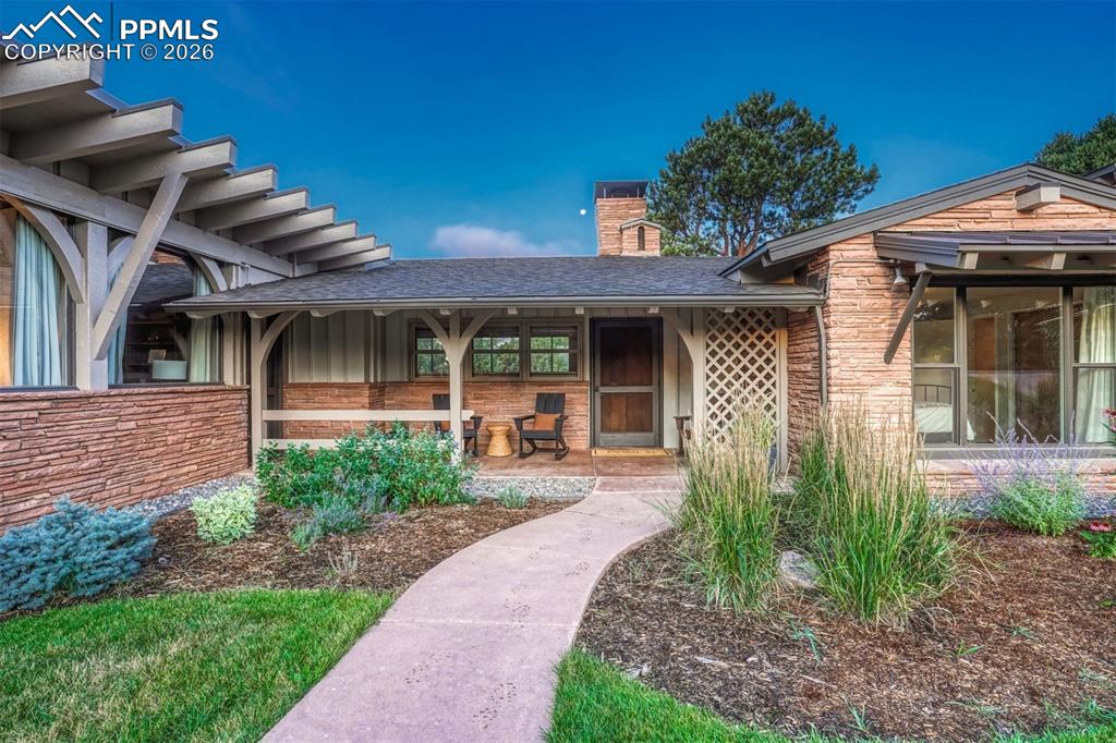 Image 32 of 46: Sunlit mornings come alive on this warm and inviting covered porch, perfect