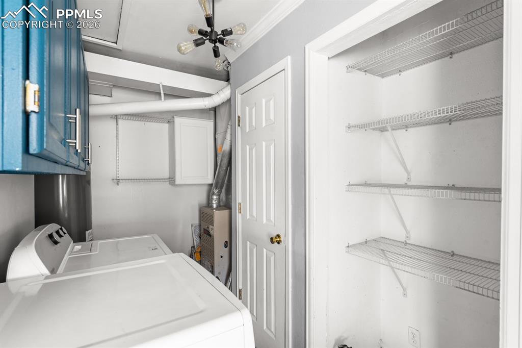 Image 24 of 32: Washer & Dryer Included!  Pantry shelving in laundry room!