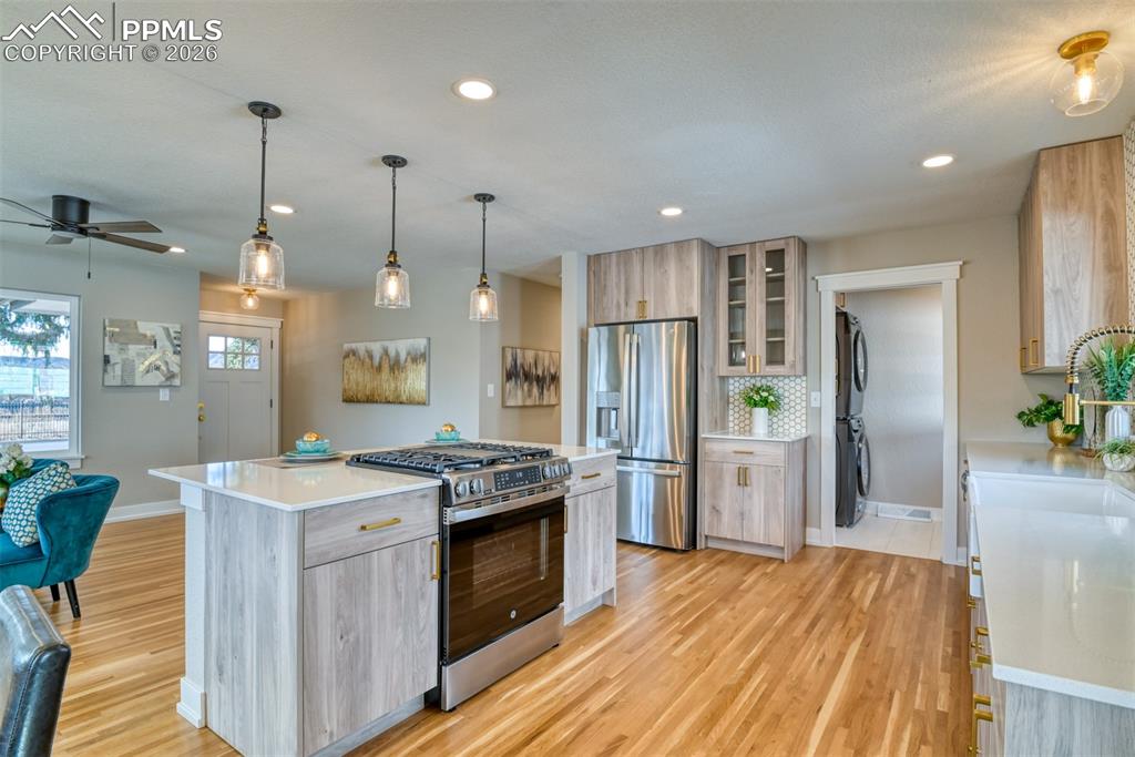 Image 15 of 35: Kitchen with stainless steel appliances, pendant lighting, ceiling fan, lig
