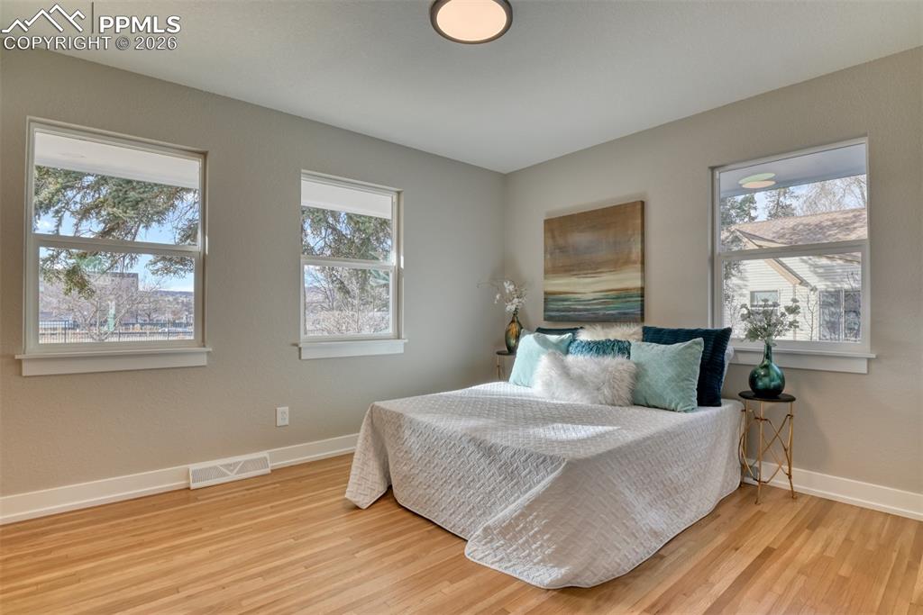 Image 17 of 30: Bedroom featuring light wood-style floors