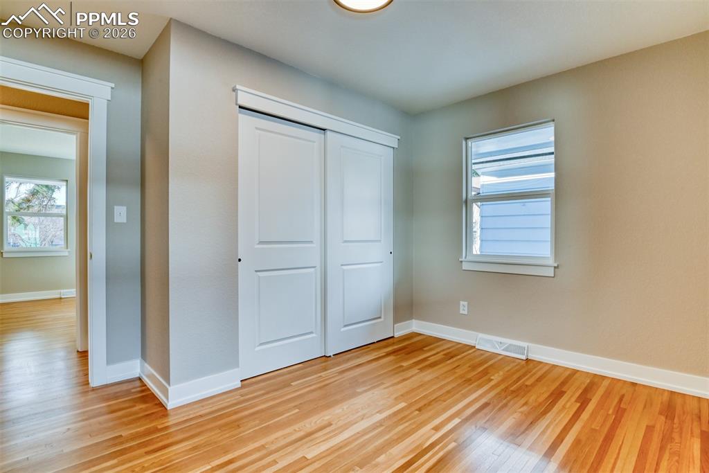Image 24 of 35: Unfurnished bedroom featuring light wood-style flooring and a closet