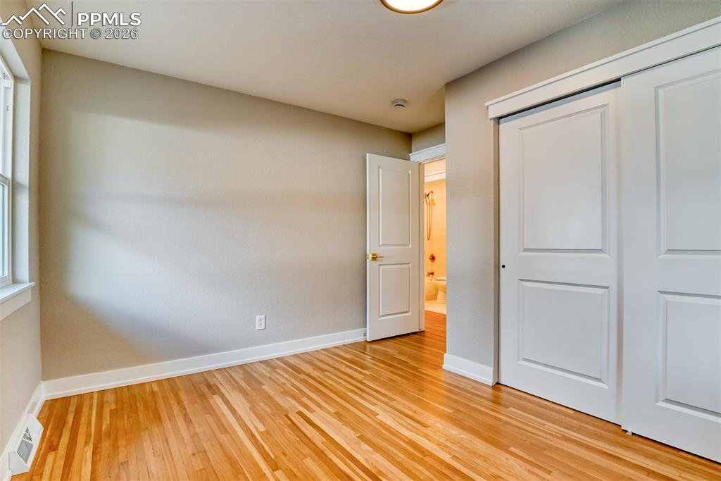 Image 25 of 35: Unfurnished bedroom featuring light wood-style flooring and a closet