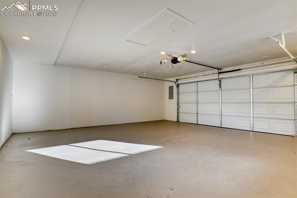 Image 27 of 30: Garage featuring electric panel