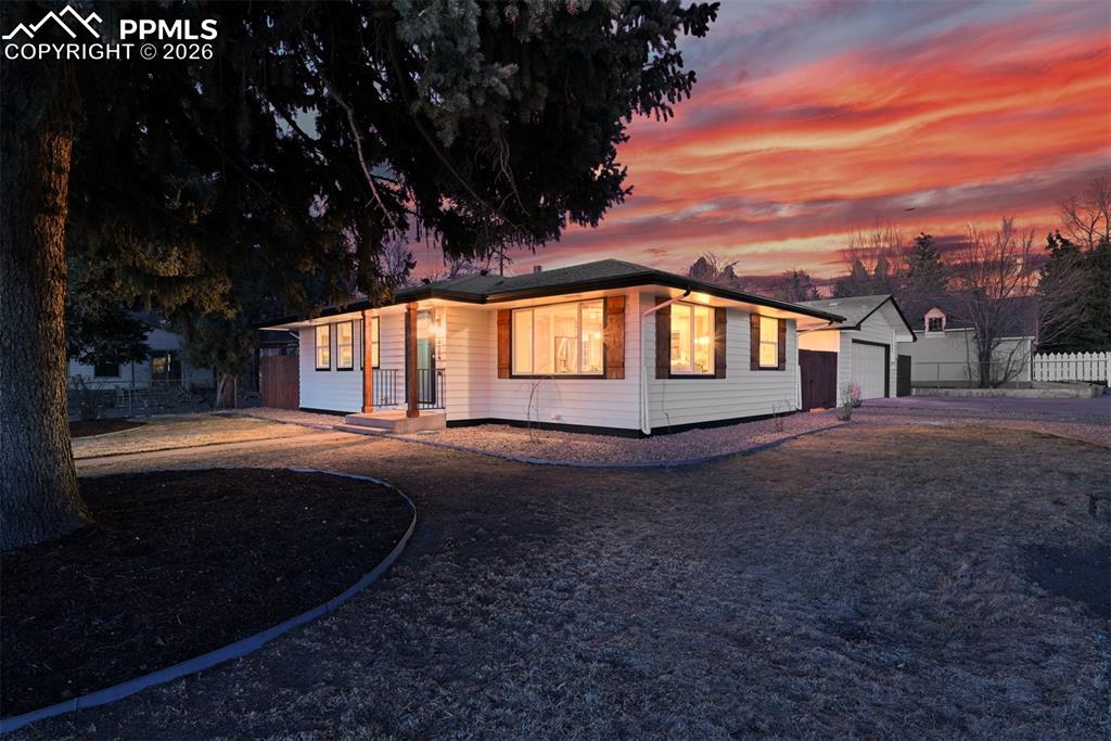 Image 28 of 30: Ranch-style home featuring a garage and driveway