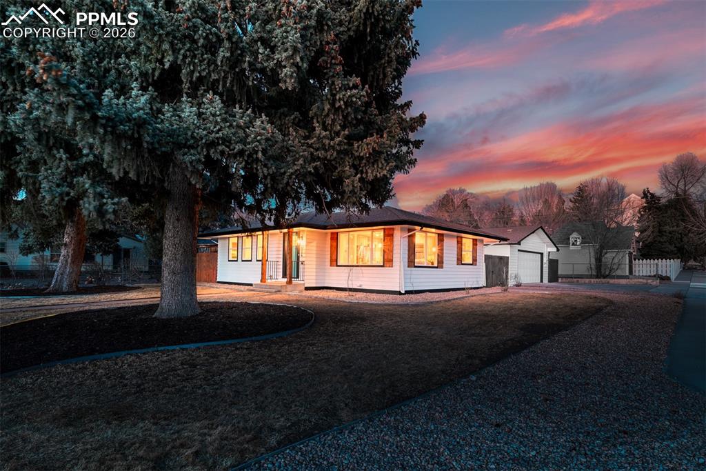 Image 30 of 35: Ranch-style home featuring driveway, a detached garage, and an outbuilding