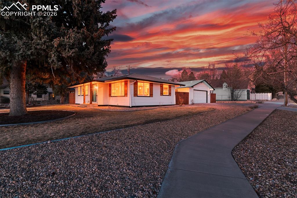 Image 34 of 35: View of front of home with driveway, an outdoor structure, and a garage