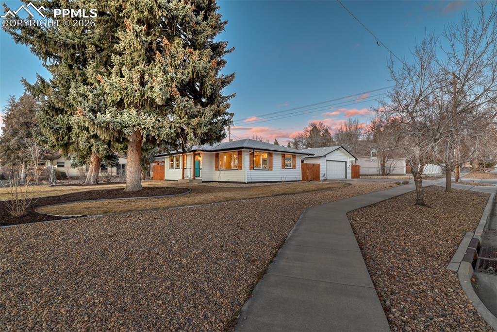 Image 7 of 35: Ranch-style home with a garage and an outbuilding