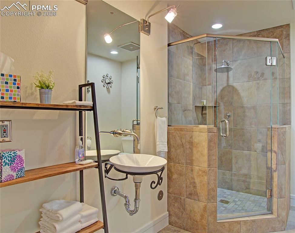 Image 16 of 20: Full bathroom featuring a stall shower and recessed lighting